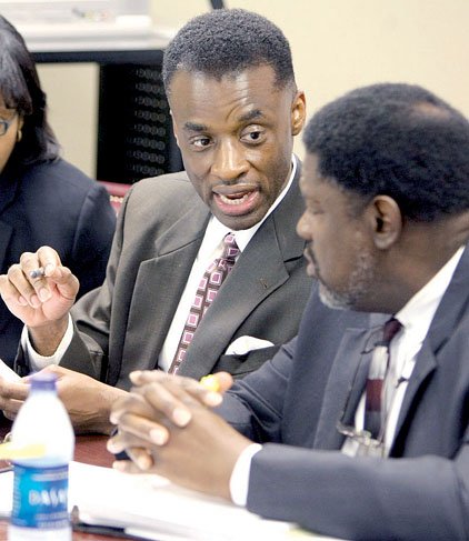 Pulaski County Circuit Judge Willard Proctor Jr. (left) confers with his attorney, Austin Porter Jr., before the start of Proctor's hearing before the Arkansas Judicial Discipline and Disability Commission on Tuesday morning.