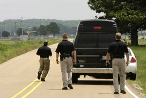 Federal prison guards walk to a van believed to be carrying Clifford J. Harris Jr., also known as rapper T.I., outside of a prison facility in Forrest City.
