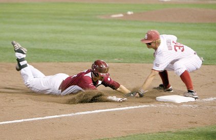 Arkansas led Oklahoma 11-0 in the eighth inning of Sunday's Norman (Okla.) Regional championship game when Razorbacks sophomore Andy Wilkins connected for his fifth hit of the game. Wilkins  was tagged out by third baseman Garrett Buechele, preventing him from hitting for the cycle. But it didn't end there. Wilkins got tangled up with Buechele, falling backward (above, center) then rising up  and going face to face with Buechele. Umpire Joe Cruz quickly stood between Wilkins and Buechele before pushing them apart as both benches emptied.