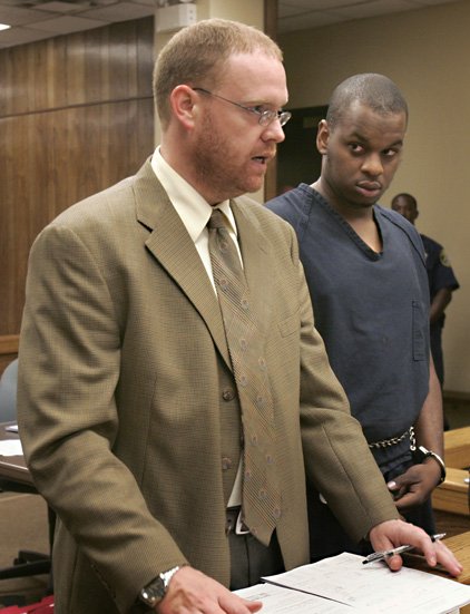 Abdulhakim Muhammad, 23, of Little Rock, right, listens as his attorney Stephen Thomas enters a not guilty plea to a capital murder charge in a Little Rock, Ark., courtroom Tuesday.