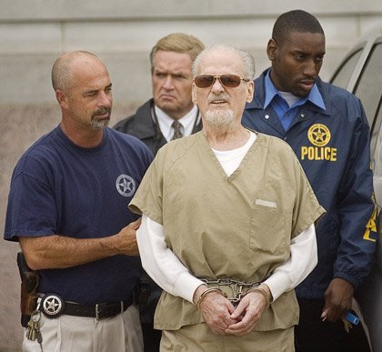  	Evangelist Tony Alamo, center is led from the federal courthouse in downtown Texarkana on Tuesday, July 14, following opening statements in his trial. 