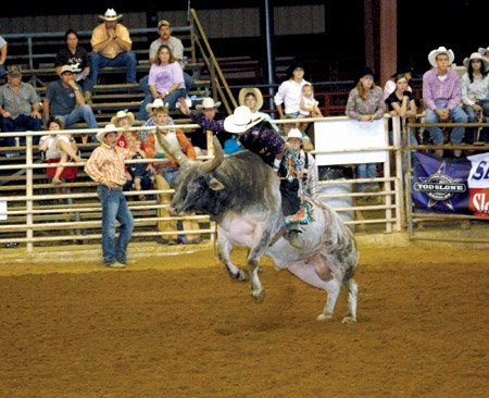 Chase Outlaw rides his bull in the Arkansas HIgh School Finals Rodeo held in Searcy. He is at the national finals this week.