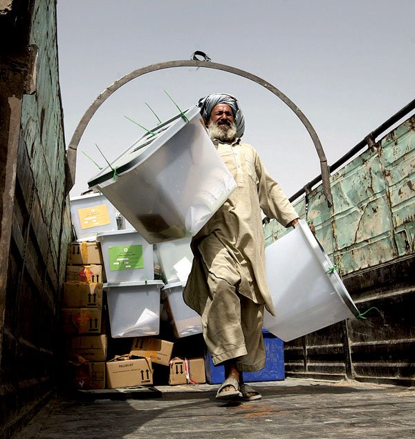 A worker unloads ballot boxes from Afghanistan's presidential election Friday in the Kandahar province.