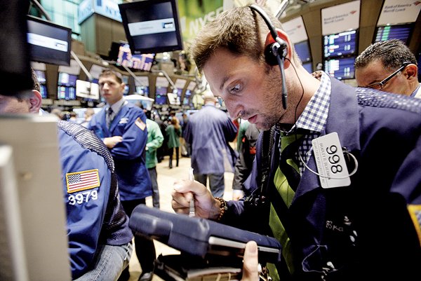 Trader Bradley Silverman (right) works on the floor of the New York Stock Exchange, where stocks rallied Friday.