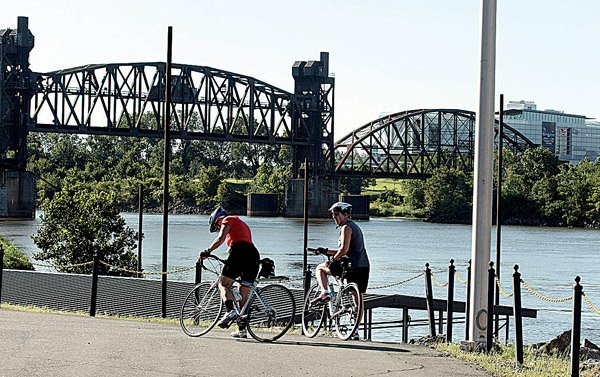 Mary Shenker (left) and Diane Goodfellow, both of Little Rock, pause during a bike ride near the Rock Island Bridge in North Little Rock on Saturday morning. 