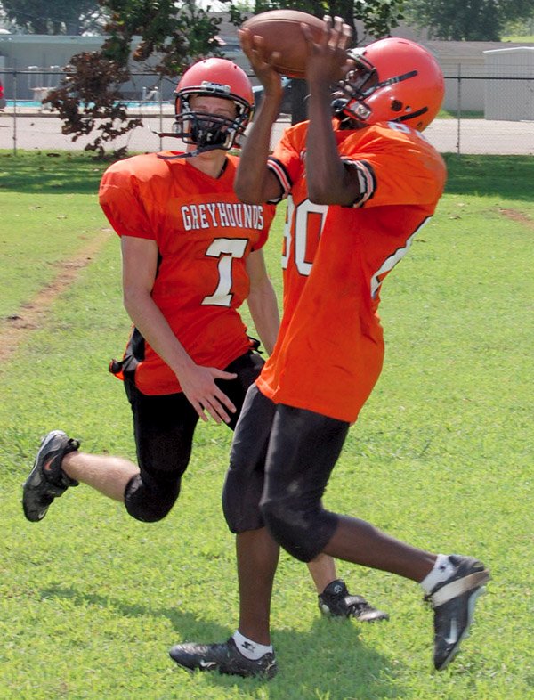 Terrell Williams catches a pass while being covered by Ryan Mc-Gaughey. 
