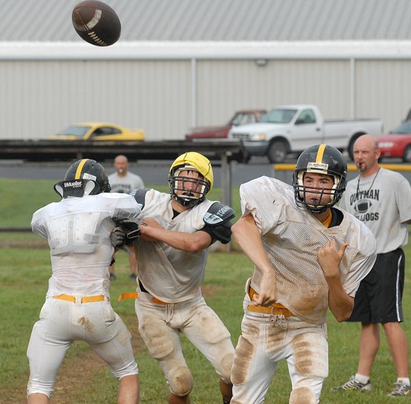 Backup quarterback Aaron Parker fires off a pass while being pursued in practice. 