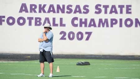 Fayetteville coach Daryl Patton watches during practice Aug. 14 at Harmon Field. The Bulldogs travel to Springdale to take on Shiloh Christian in an exhibition game today at the Field of Champions.