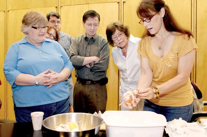 Louise Palermo (right), curator of education at the Arkansas Arts Center, introduces a class of docents in training to "Ankh-en-orange-en", a mummy figure made of parts including a dried orange.