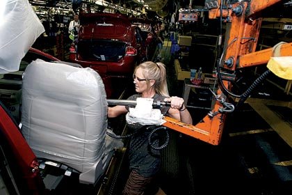 Ford worker Rashell Rule installs seats in a 2010 Ford Focus at the Wayne Stamping and Assembly Plant in Wayne, Mich., on Wednesday.