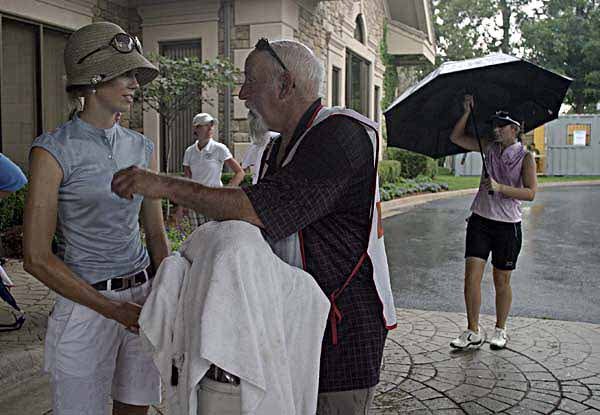 Anna Rawson (left) and several other LPGA Tour players found shelter during one of the rain delays at last year's P&G Beauty Northwest Arkansas Championship at Pinnacle Country Club in Rogers. 