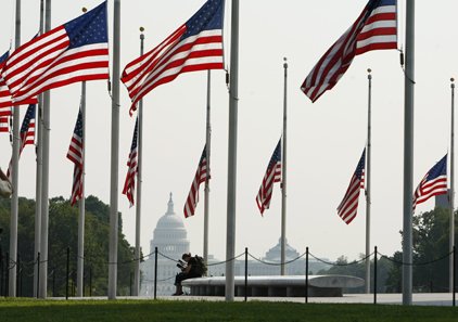 The U.S. Capitol in Washington is seen between flags at the Washington Monument at half-staff, Wednesday, in honor of the passing of Sen. Edward Kennedy, D-Mass.