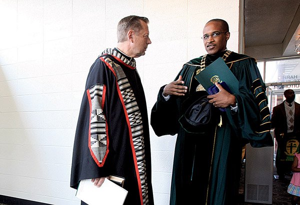 The Rev. Michael Pfleger (left) and Philander Smith College President Walter Kimbrough talk Thursday morning before the school's opening convocation.