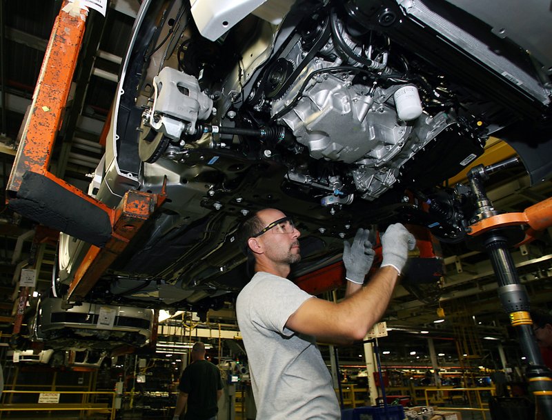 Walt Roche installs a motor mount on a 2010 Ford Focus at the Wayne Stamping and Assembly plant in Wayne, Mich.