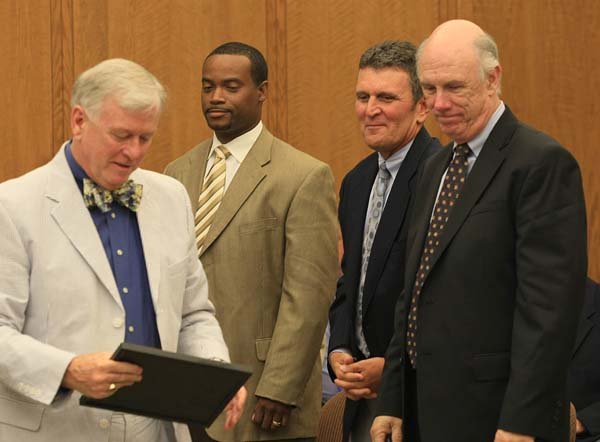 Arkansas Lottery Director Ernie Passailaigue awards the first lottery retail license to Murphy Oil representatives (from left) Carl James, Kyle Williams and Hank Heithaus during an Arkansas Lottery Commission meeting Wednesday.