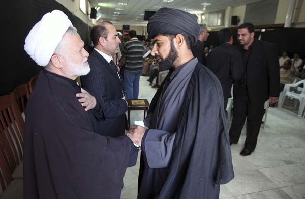 Men pay their condolences after the death of Shiite leader Abdul-Aziz al-Hakim, at his party headquarters in Baghdad on Thursday.