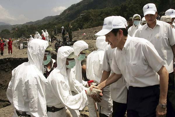 Taiwan's President Ma Ying-jeou shakes hands with soldiers working Thursday in the village of Hsinkai, which saw flooding and mudslides when Typhoon Morakot hit Taiwan.