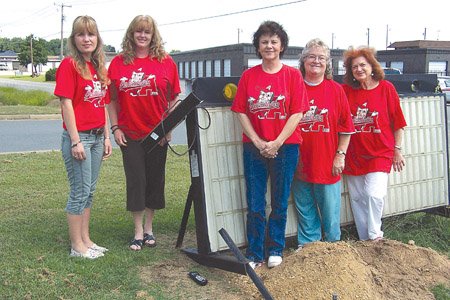Tammy Stipes, from left, Marcia Pressler, Maleta Henley, Betty Lyons and  Mary Margret Davidson stand in front of the broken sign for the White County Aging Program. The organization is selling spaces to have names engraved on the new sign  to help cover its cost.