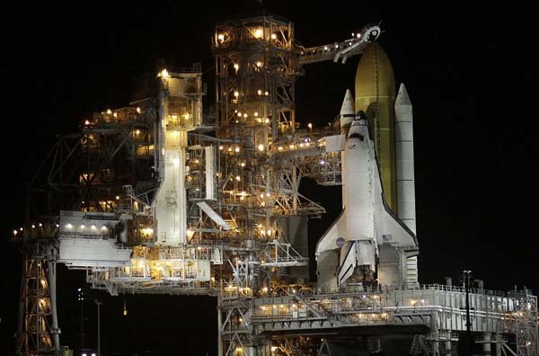 The space shuttle Discovery sits on a launchpad before sunrise Friday at Cape Canaveral, Fla.