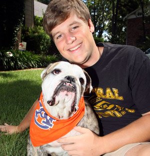 Blake James and Maggie, his English Bulldog, outside his Little Rock home, Aug. 23. James will be a senior linebacker for Little Rock Central.