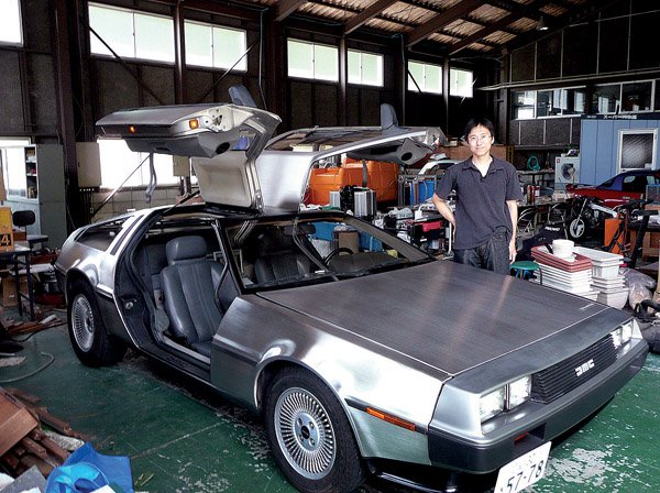 Tomoyasu Fujii of Hiroshima, Japan, shows his 1981 DeLorean that's been converted into an electric car.