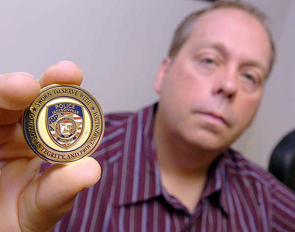 Jacksonville police officer John Forte shows off a medal that was awarded to him by the Jacksonville Police Department in the weeks after a major shootout in August 2008. 