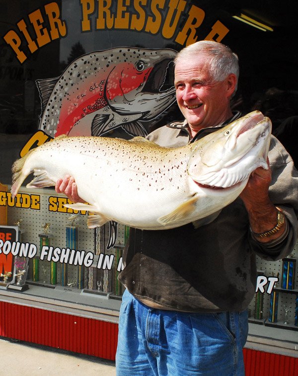 Tom Healy of Rockford, Mich., shows a 41-pound, 7 1/4 ounce brown trout he caught in the Manistee River near Manistee, Mich.
