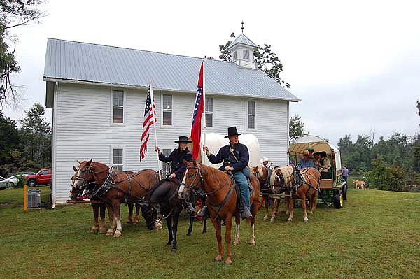 Re-enactors gather Saturday at the Old Yell Lodge in Carrollton before a parade into town. Fifteen orphaned children 150 years ago
spent their first night back in Carrollton at the lodge, which has since burned and been replaced by the current building.