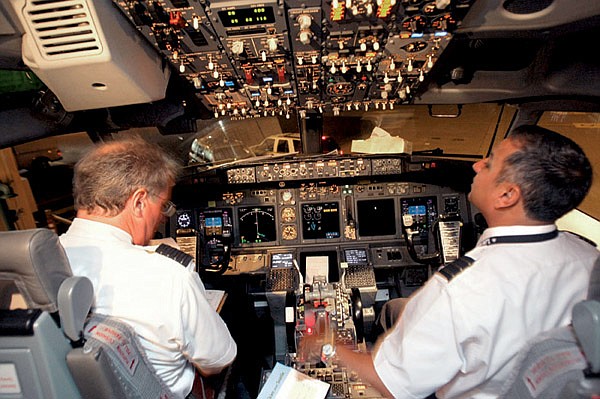 Alaska Airlines Capt. Mike Adams and co-pilot Oscar Vela prepare for a test flight using a new satellite-based navigation system in August.