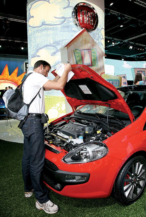 A visitor looks at a Fiat Punto Evo on display last week at the Frankfurt Motor Show in Germany.