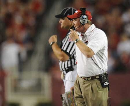 Arkansas coach Bobby Petrino speaks to a game official during the Hogs' 52-41 loss to Georgia Saturday in Razorback Stadium. 
