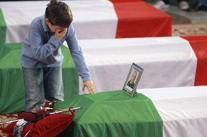 Martin Fortunato, the 7-year-old son of Lt. Antonio Fortunato, stands at his father's coffin Monday in Rome during a state funeral for six soldiers killed last week in Afghanistan.