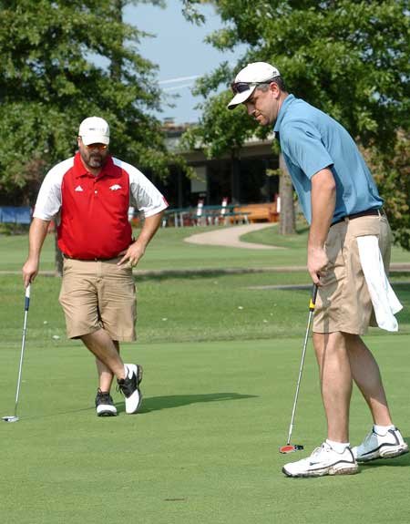 Dale Reed, right, putts in on No. 5 as partner Chad Reaves looks on Monday during the Washington Regional Medical Center tournament at Paradise Valley in Fayetteville. 
 