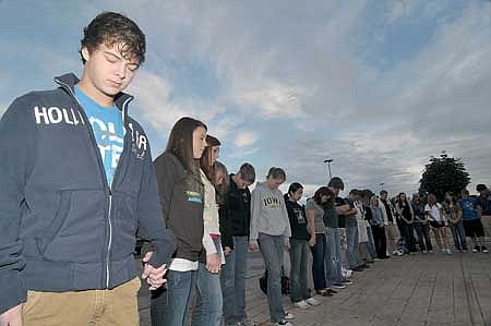 Bentonville sophomores Dylan Poe, left, and Ashton Dawson, second from left, led students in prayer during a See You at the Pole rally at Bentonville High School on Wednesday morning. 