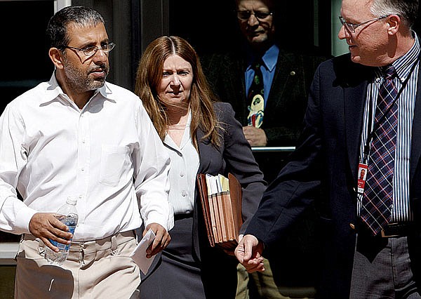 Mohammed Wali Zazi (left), whose son was indicted on a charge of conspiring to use bombs against targets in the United States, leaves a Denver courthouse Thursday with U.S. marshals.