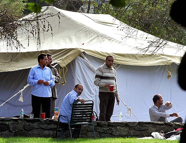 People gather around a tent Wednesday on the estate in Bedford, N.Y., owned by Donald Trump. The tent was later taken down.