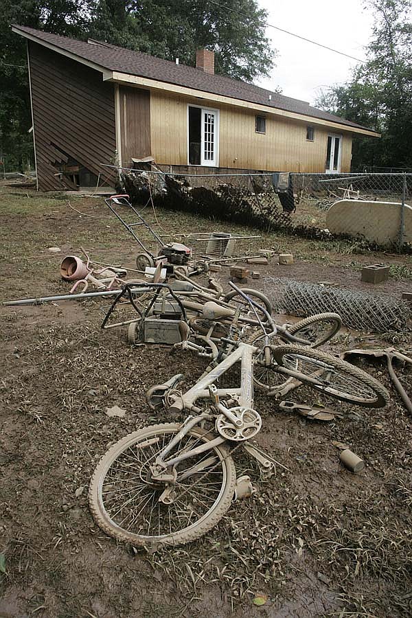 Mud-covered bicycles lay in front of a house Wednesday in Lilburn, Ga., after floodwaters from the Yellow River receded.
