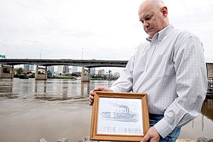 William Stevens holds a copy of a print of the Lizzie Simmons, a riverboat converted into a Confederate gunboat during the Civil War and renamed the Pontchartrain. 