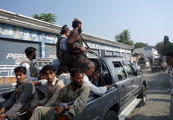 Armed members of a private militia patrol with army troops Thursday in Kanju near Mingora, the main town of Pakistan's troubled Swat Valley.
