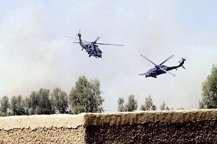 A U.S. military medivac helicopter (left) is escorted by a second helicopter Friday as it lifts off after picking up a Marine wounded in a firefight in Afghanistan's Nawa district.