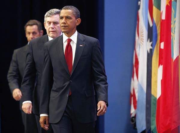 President Barack Obama is followed by British Prime Minister Gordon Brown and French President Nicolas Sarkozy as they prepare to deliver a statement Friday on Iran's nuclear facility during the G-20 summit in Pittsburgh.