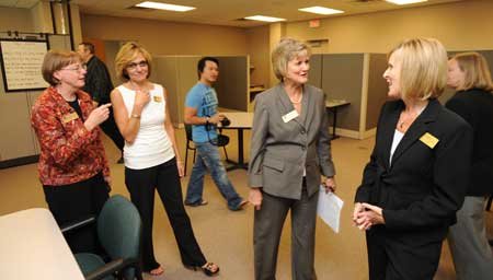 Brenda Green, NorthWest Arkansas Community College associate dean for learner services for Washington County, right, speaks with NWACC President Becky Paneitz as staff members give tours of the college's newly dedicated Washington County Center on Friday in Springdale. 