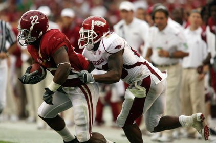 Arkansas' Ramon Broadway tries to tackle Alabama's Mark Ingram on Saturday.