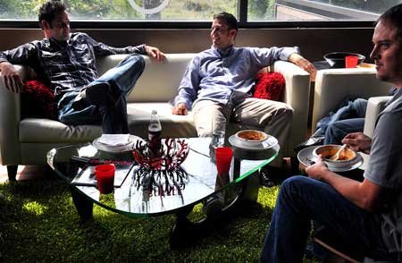 Creative director Joey Nelson of Fayetteville, left, director of technology John Cox of Rogers and senior developer Shawn Camp of Siloam Springs sat in the lounge area at the Rockfish Interactive office in Rogers. 

