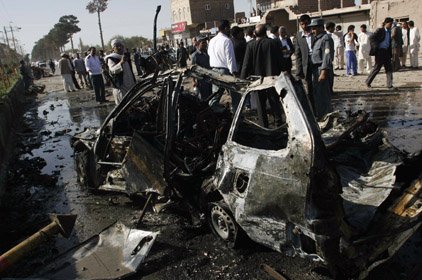 A damaged vehicle is seen at the site of a blast in Herat, Afghanistan on Sunday.