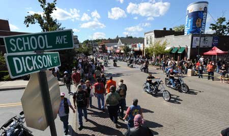 Motorcyclists and pedestrians make their way along West Dickson Street during the 10th annual Bikes, Blues & BBQ Motorcycle Rally on Saturday in Fayetteville. 