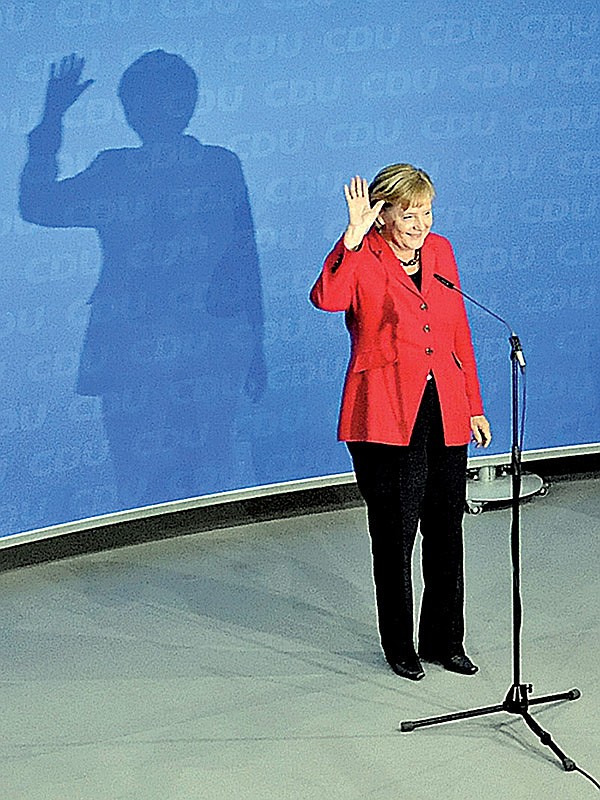 German Chancellor Angela Merkel, top candidate of the Christian Democratic Union Party, waves after the German general elections in Berlin on Sunday.
