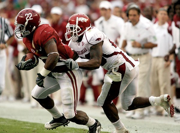 Alabama running back Mark Ingram breaks away from Arkansas defensive back Ramon Broadway during Saturday's game in Tuscaloosa, Ala. Broadway is one of several Razorbacks who have given up big plays in the secondary.