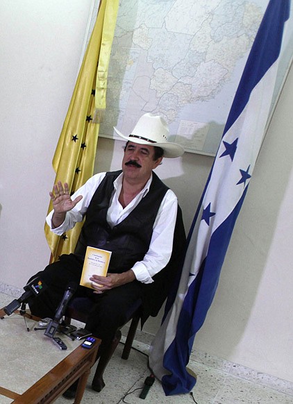 Honduras' ousted President Manuel Zelaya, holding a copy of the Honduran Constitution, speaks during a press conference at the Brazilian embassy in Tegucigalpa, Monday.