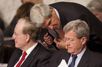 Sen. John Kerry (center), D-Mass., confers with Senate Finance Committee Chairman Max Baucus (right) of Montana and Sen. Jay Rockefeller, D-W.Va., as the committee meets Tuesday.